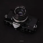 دوربین Olympus OM-1 با لنز 50mm f/1.8